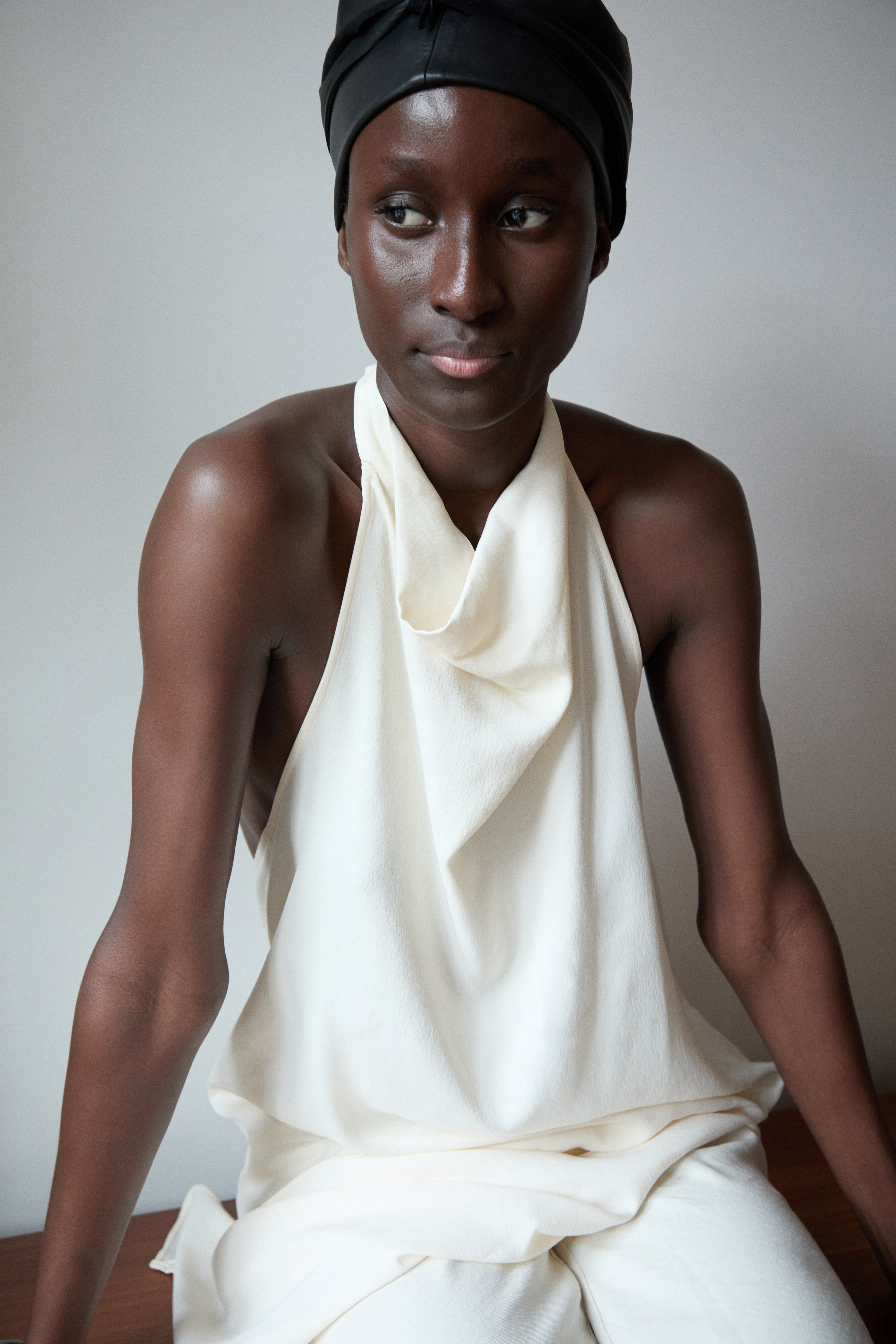 Within walls and clean lines, her presence settles into place. Wood, leather, fabric, and skin meet without effort, as light moves across them all, keeping everything in balance. fashion editorial by rebekka eliza